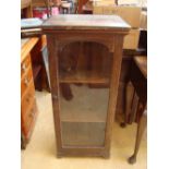 A mahogany floor standing glass cabinet.