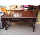 A Cuban mahogany desk, united by a wrought iron curly cubed cross stretcher.