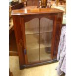 An Edwardian glass cabinet.