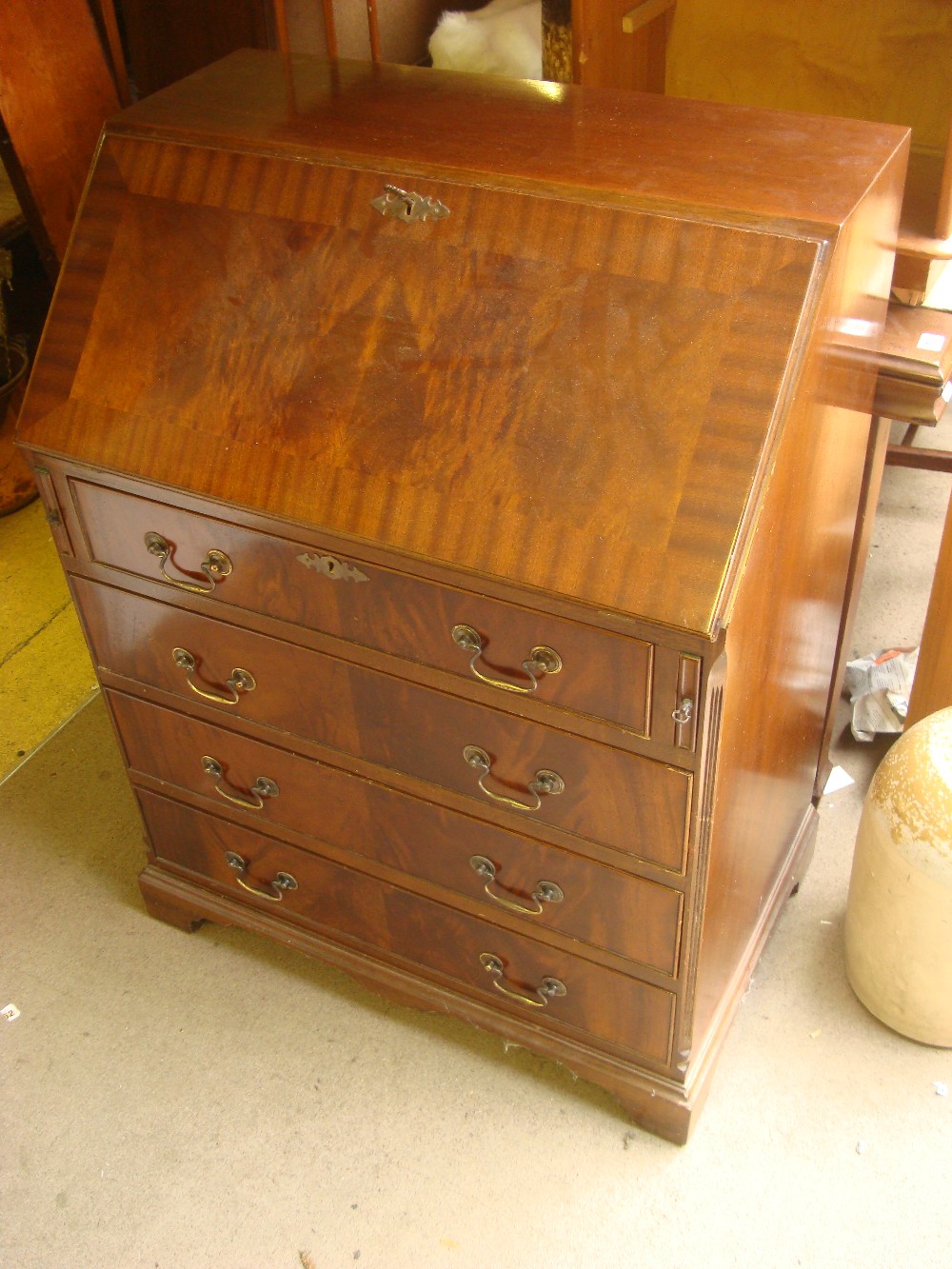 A 20th Century full front bureau with four drawers, writing compartment, pigeon holes,