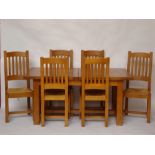 A modern light oak extending table, on square chamfered legs united by an H stretcher.