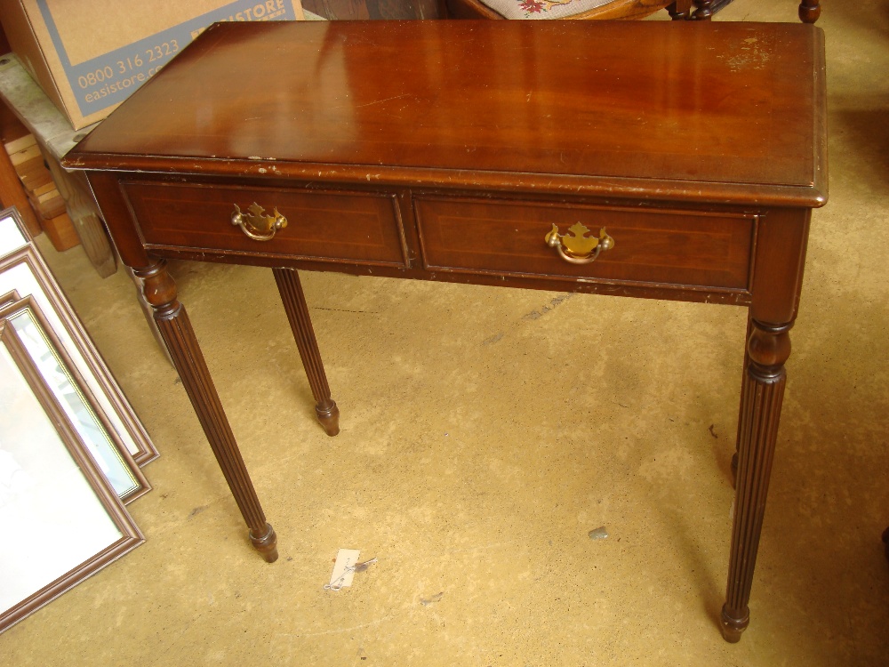 A 20th Century side table with reeded legs and two drawers.