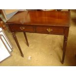 A 20th Century side table with reeded legs and two drawers.