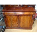 An early Victorian mahogany side cabinet with shaped frieze drawer over a pair of cupboard doors,