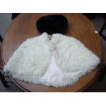 A white stole and fur beret.