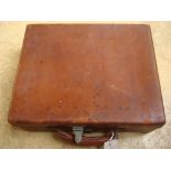 A leather travelling case, lined in green Morocco containing various silver topped bottles etc,