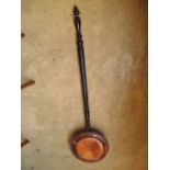 A 19th Century copper warming pan with ebonised turned handle.