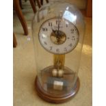 A 20th Century Bulle electric clock under dome, with white enamel dial on turned walnut base, 38.