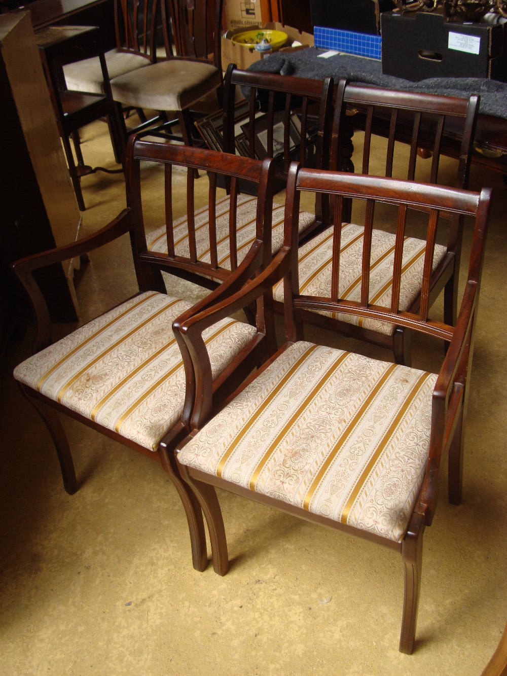 Four reproduction mahogany dining chairs.