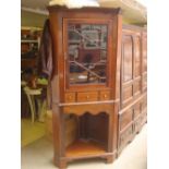 An early 19th Century and later free standing mahogany corner cupboard,