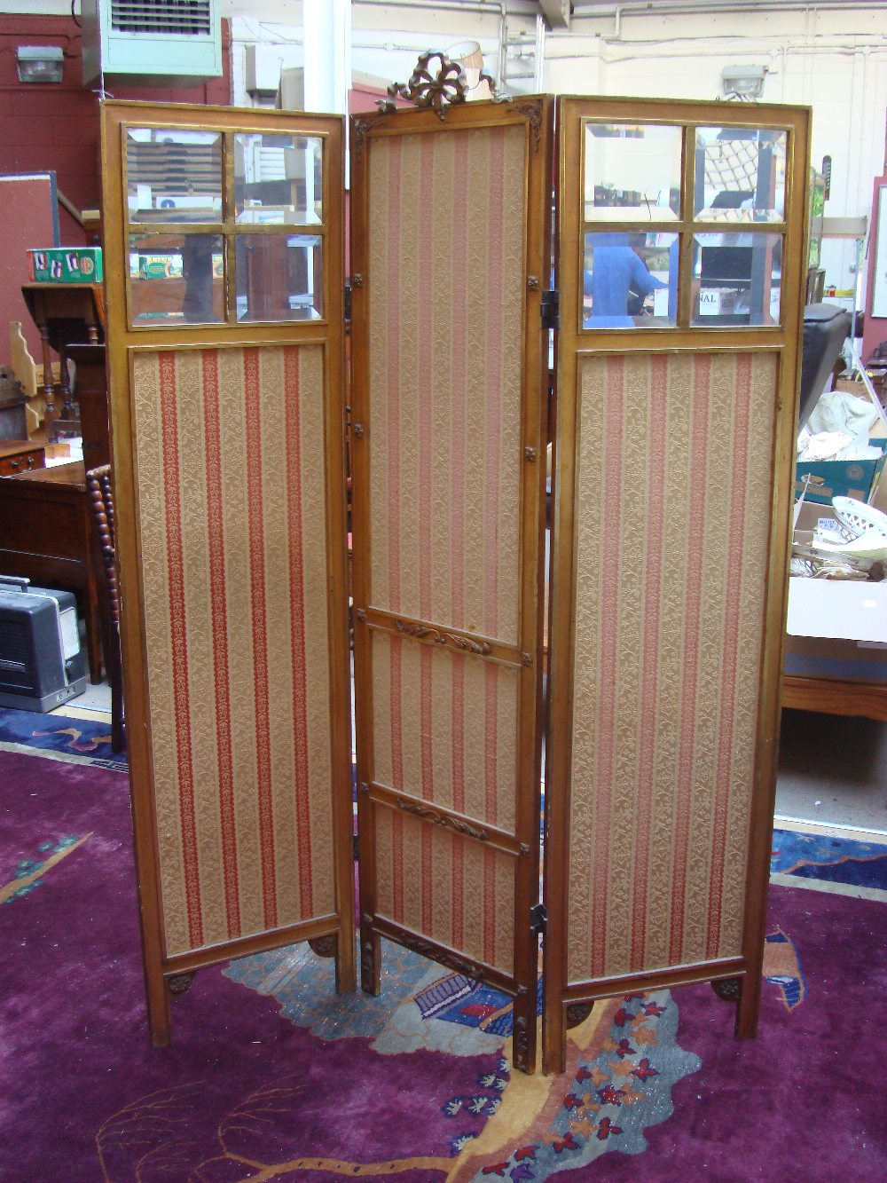 A Victorian gilt wood three fold room screen, with fabric lined and bevelled glass panels.