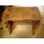 An early 20th Century oak stool, on stretcher base.