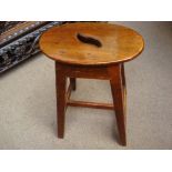 An early 19th Century milking stool.