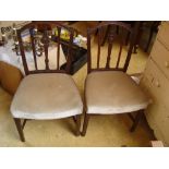 A pair of early 19th Century Hepplewhite style chairs with stuffover seats.