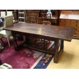 An oak refectory table with a three plank top with cleated ends on turned supports,