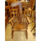 An early 20th Century beech and elm high back turned armchair, with pierced and shaped back splat,