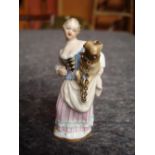 An 18th Century Meissen porcelain scent bottle in the form of a woman carrying a pug dog under her