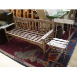 A wooden bench with a wooden white painted French garden chair.