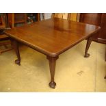 A late Victorian walnut wind out dining table, on cabriole legs with two extra leaves.