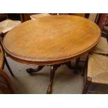 A 19th Century walnut loo table above a shaped support and four foliate carved legs.