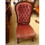 A 19th Century buttonback chair on cabriole legs.