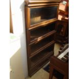 An early 20th Century oak four tier Globe Wernicke sectional glazed bookcase,