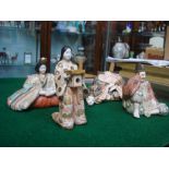 A group of four 19th Century Japanese Meiji period satsuma figures comprising a seated shogun