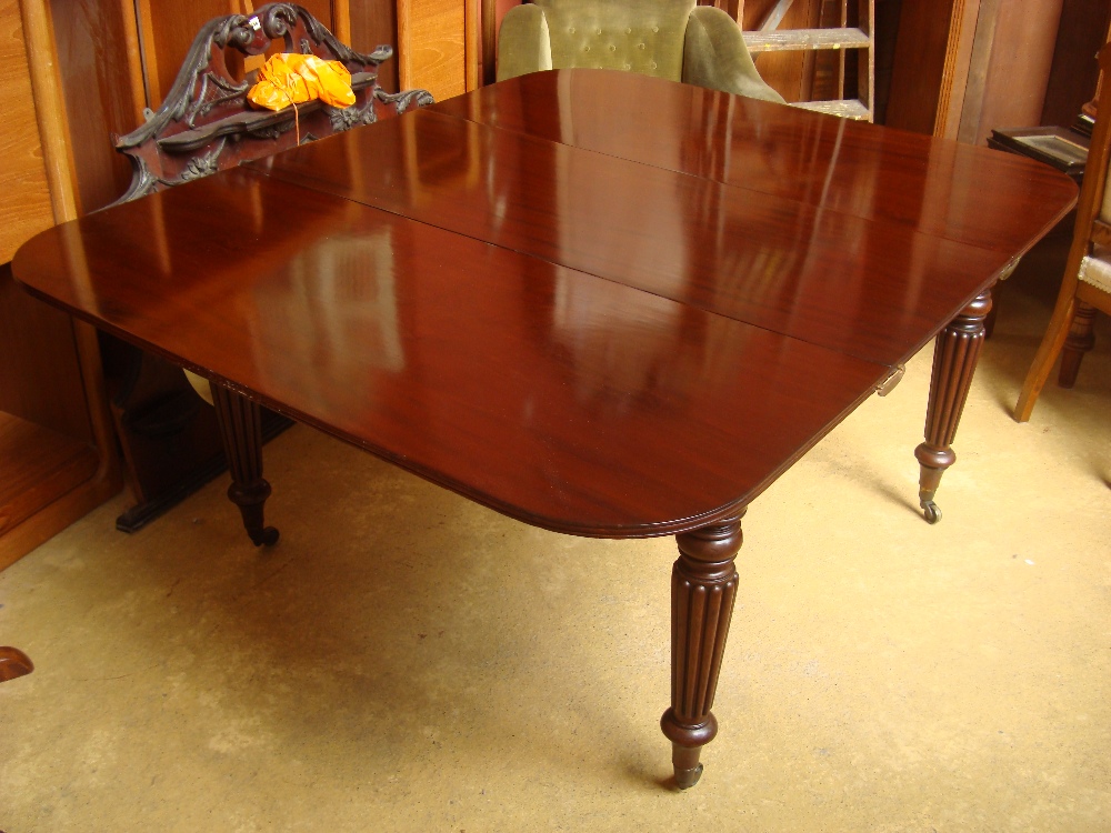 A 19th Century mahogany dining table on four reeded legs, on original casters. 158 x 130cm.