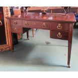 A late 19th Century American mahogany partners desk with five drawers either side with ornate