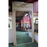 A large French Country House console mirror with panel carved frieze depicting flaming torch and