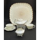 A Belleek First Period Thorn pattern part tea service comprising fluted square tray, teapot,