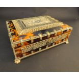 An Anglo Indian tortoiseshell casket, pierced panels with central bird motif on four claw feet,