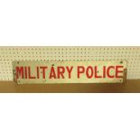 A tin military police vehicle sign