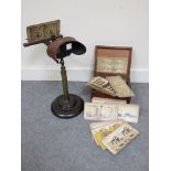 An American stereoscopic viewer on brass and wood stand with box of cards,