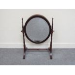An Edwardian mahogany oval dressing chest mirror with line inlay decoration, splayed legs,