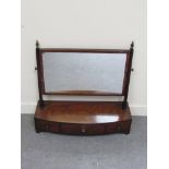 Circa 1860 a flamed mahogany bow front dressing chest mirror the brass finial's on reeded square