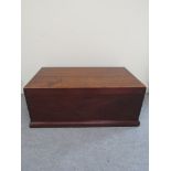 A 19th Century camphor wood chest with exposed dove tail joints the hinged lid over a plinth base,
