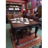 A Victorian mahogany dining table with extra leaf and winder,