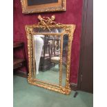 A circa 1860 gilt cushion form pier mirror surmounted by ribbon and flaming torch,