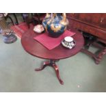 A George III mahogany tilt top wine table