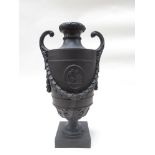 A Wedgwood black basalt oviform two handled vase, high relief classical plaque and swag decoration,