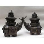 A pair of Meiji period bronze sensors in the form of elephants surmounted by pagodas
