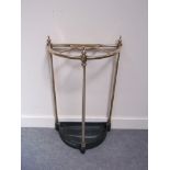 A brass and cast iron umbrella stand