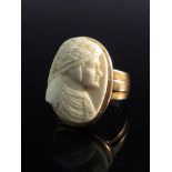 A gold 18th Century ring with a white coral insert depicting a Renaissance gentleman