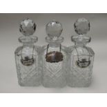 Three crystal spirit decanters with Whisky,