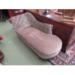 A Victorian button back chaise longe turned legs to castors,