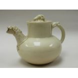 A 19th Century cream ground teapot with lion mask spout (repaired),