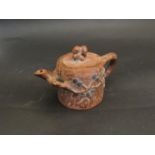 A handmade Chinese Yixing red clay teapot decorated with flowering cherry and a squirrel finial,