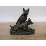 A 20th Century bronze statue of two Alsatians on green patinated base, bearing signature L.