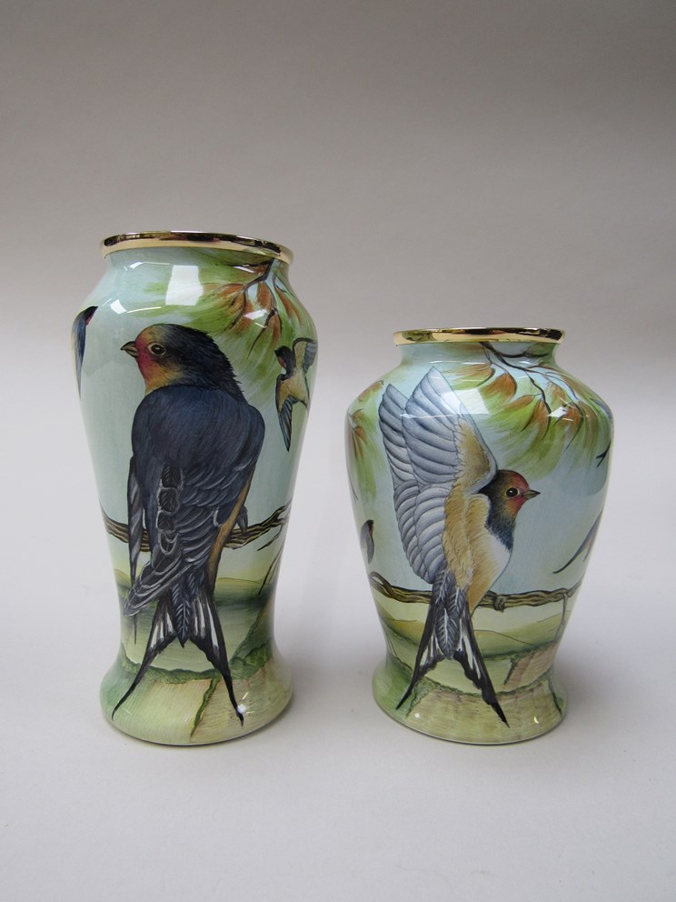 Two Moorcroft Enamels "Swallows" vases designed by Sandra Dance, 8cm and 9cm tall,